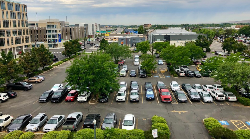 A surface parking lot filled with cars.