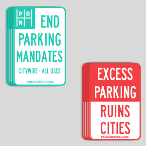 Two sticker designs on a gray background. They are both in the style of parking signs. One sticker is teal and says End Parking Mandates - Citywide All Uses parkingreform.org with a logo of PRN in the corner. The other is red and says "Excess Parking Ruins Cities."